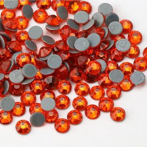 Nahaufnahme glänzender Hyacinth Hotfix Glas-Strasssteine (SS30). Zeigt Details der Facetten und den schmelzenden Kleber für Textilien. Ideal für DIY.