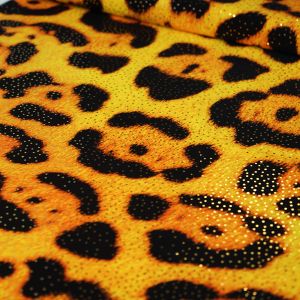 Bielastischer Lycra Stoff in ocker-schwarz mit Leopardenmuster und glitzernden Foliendruck-Pünktchen in gold. Der Stoff ist perfekt für Bademode, Kürkleider, Tanzkleider.